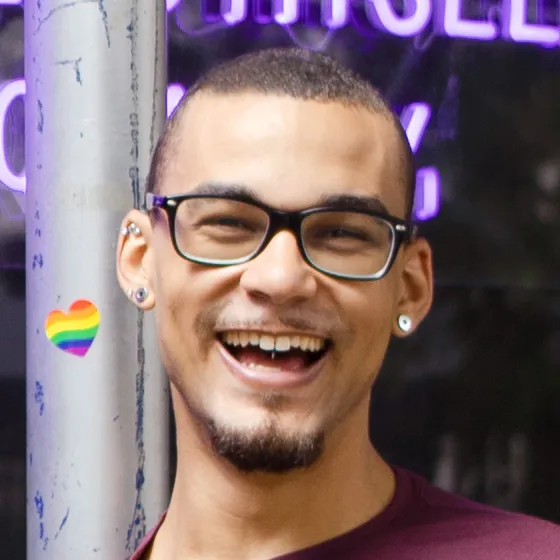 Manny smiling infront of the Stonewall Inn